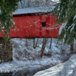 Vermont covered bridge in Northfield vermont covered in snow and painted red