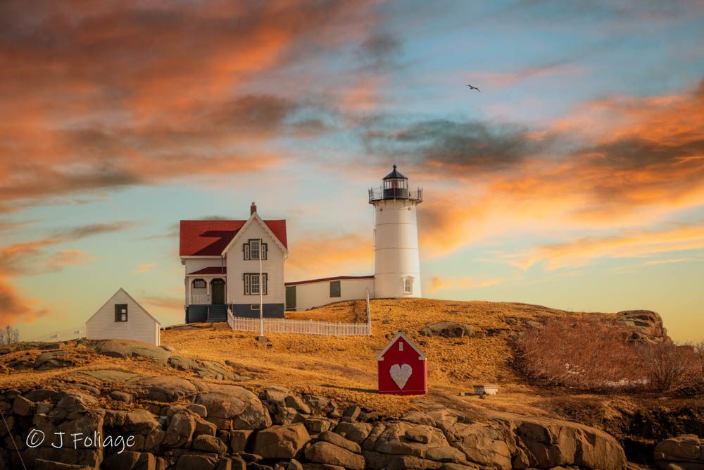 Nubble Lighthouse decorated with a red illuminated heart for Valentine's Day in York Maine.