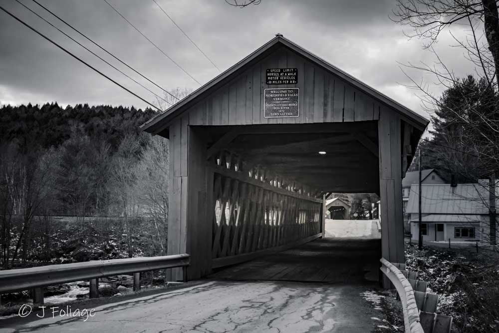 Monochrome view of the Station Covered Bridge in Northfield, Vermont, captured in soft overcast light to emphasize its texture.