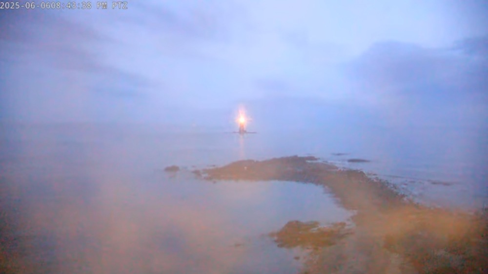Whaleback lighthouse surrounded by frozen sea smoke