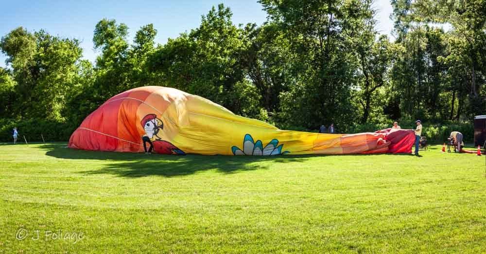 Close-up of a hot air balloon being inflated with a high-powered fan on the Quechee Green festival grounds.