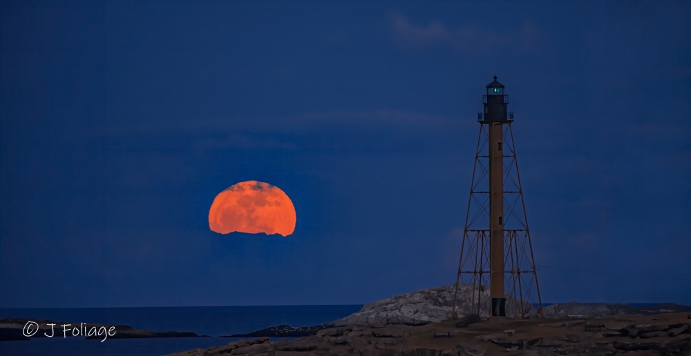 Full moon rising against Marblehead Lighthouse
