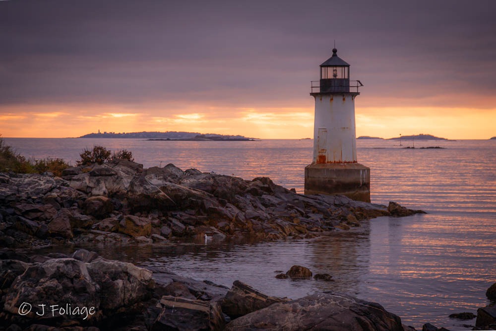 A radiant dawn on Salem Sound looking past Winter Island's Lighthouse